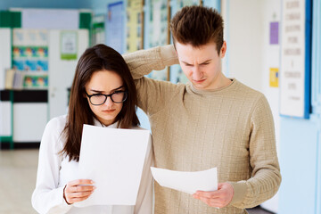 Disappointed college students with bad test results. Two learners failed their final examination