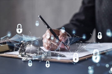 African American businesswoman in formal wear signing the contract to prevent probability of risks in cyber security. Padlock Hologram icons over the working desk. Women in business concept.