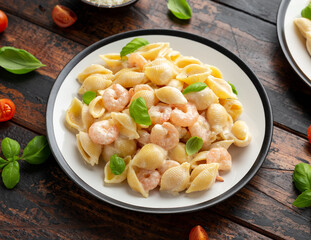 Italian conchiglie prawn, shrimp pasta in a creamy sauce on plate.