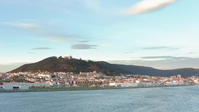 View to Viana do Castelo cityscape over the Lima river waterfront - Aerial wide slide tracking shot