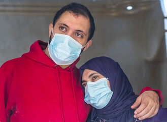 Arabic family looking from the window during the quarantine time