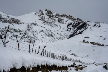 panoramic landscape of winter mountains, passes and snow-covered trees in the Caucasus 
