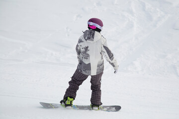 A snowboarder on a snowboard. Extreme winter sports.Rest in winter.