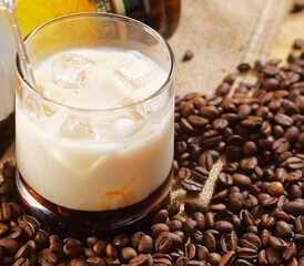Unmixed White Russian cocktail made with vodka, coffee liqueur and cream served with ice in an Old Fashioned glass.