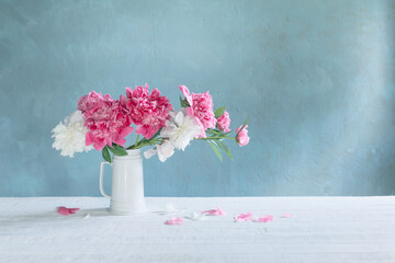 bouquet of pink and white peonies  on background old wall