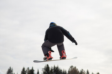 A snowboarder on a snowboard. Extreme winter sports.Rest in winter.