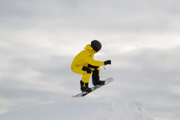 Naklejka na ściany i meble A snowboarder on a snowboard. Extreme winter sports.Rest in winter.