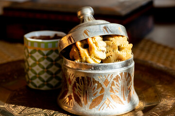 Arabic sweets, maamoul and coffee on traditional background