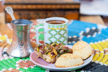 Arabic sweets, maamoul and coffee on traditional background