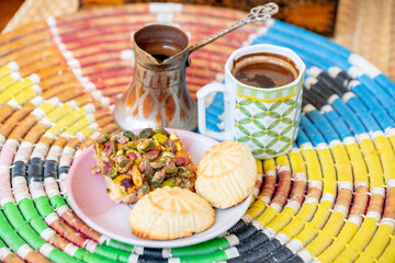 Arabic sweets, maamoul and coffee on traditional background