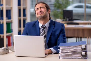 Young male employee working in the office