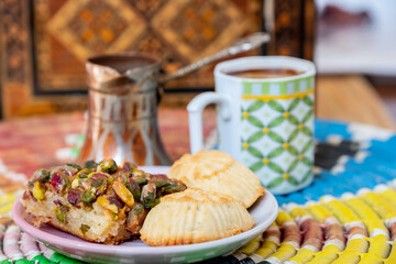 Arabic sweets, maamoul and coffee on traditional background