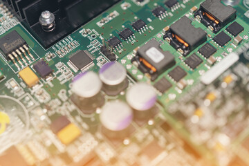 Electronic circuit board with electronic components close up. Blurry background.