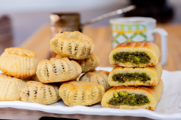 Arabic sweets, maamoul and coffee on traditional background