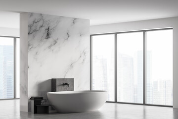 Fototapeta na wymiar White marble bathroom with white bathtub and towels near window