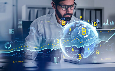 Handsome beard trader in glasses analyzing cryptocurrency rates, side view businessman working on laptop. Double exposure. Internet trading. Hologram Globe and diagrams