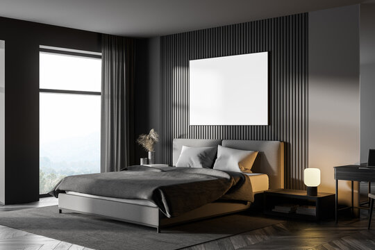 Dark bedroom interior with wooden parquet, a large window, a gray bed and two bedside tables. A cabinet with mirror. White poster on wall. mock up