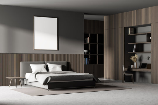 Bedroom interior with king size bed, a bookshelf, a table and a chair. Large vertical poster is hanging above the bed. 3d rendering. Mock up.