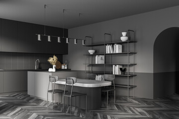 Dark modern kitchen interior. Dining area with table. Wooden parquet floor.