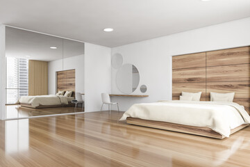 Bed and linens in wooden bedroom with mirror and parquet