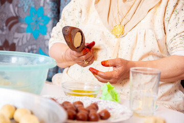 Arabic woman hands making eid sweets ,cookiesand mamoul