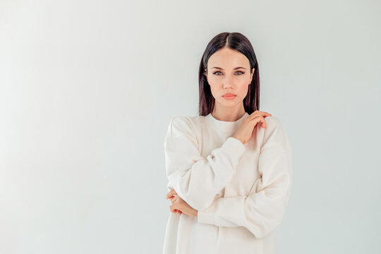Mock-Up. portrait of a beautiful girl with black long hair in a hoody on a white background. the concept of sport