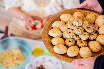 Arabic woman hands making eid sweets ,cookiesand mamoul