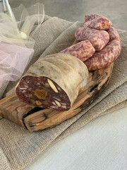 Food concept: Typical Tuscan meats on wooden chopping board