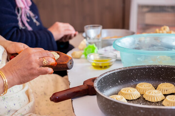 Arabic woman hands making eid sweets ,cookiesand mamoul
