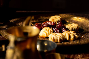 Arabic sweets, maamoul and coffee on traditional background