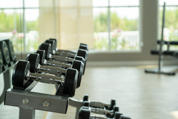 Obraz na płótnie Canvas Rows of dumbbell racks at the fitness gym.