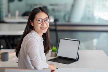 Image  young of  Asian woman working at the office looking at camera. Mock up.