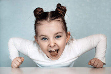 Portrait of emotional little girl at home. High quality photo