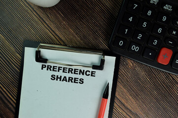 Preference Shares write on sticky notes isolated on Wooden Table.