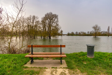 A bench facing a flooded countryside