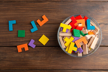 Creative idea concept - wooden puzzle in bowl with spoon. Develop new idea, food for inspiration.