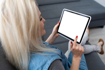 hands holding smart tablet with app smart home on home living room as backgrounds.