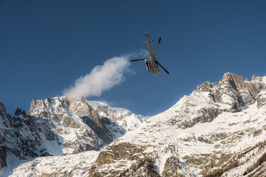 Mont Blanc mountain range (Italian side) and helicopter taking off.