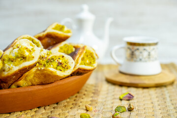 Fototapeta na wymiar Ramadan sweets qatayef with white background and arabian coffee cups