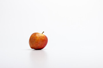 A ripe red apple isolated on a white background.