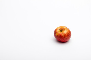 A ripe red apple isolated on a white background.