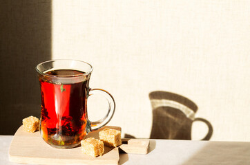 Black tea with sage herbs in a glass cup for drinking tea on a sunny day. Space for text