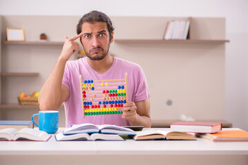 Young male student preparing for exams at home