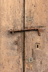 Old door with rusty iron bolt