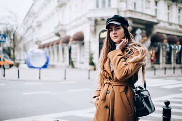 Fototapeta premium Pensive woman in coat on street