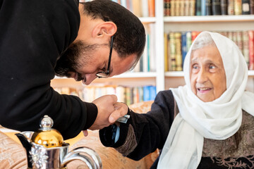 Arabic family enjoy eid celebration with grandmother while laughing together