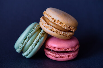 colorful macaroons on dark blue background