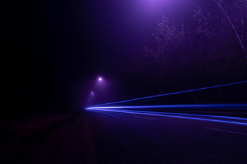 light trail of a car on foggy night