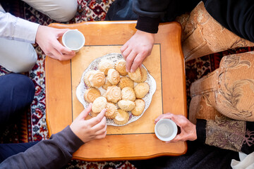 a bunch of people eating and enjoying Eid