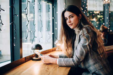 Dreamy female surfing smartphone during break